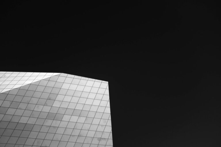 Minimalist building facade against a dark sky