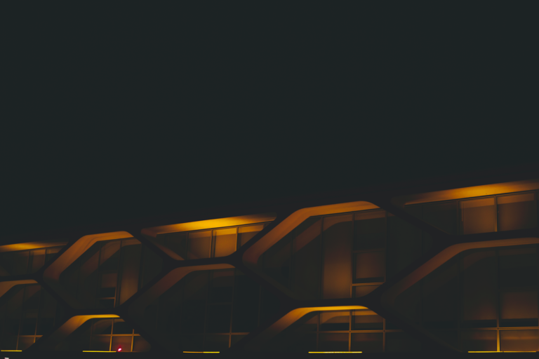 Building facade lit by neon lights at night